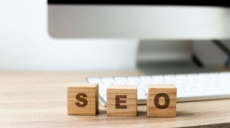how seo increases visibility for your website, seo wood blocks in front of computer
