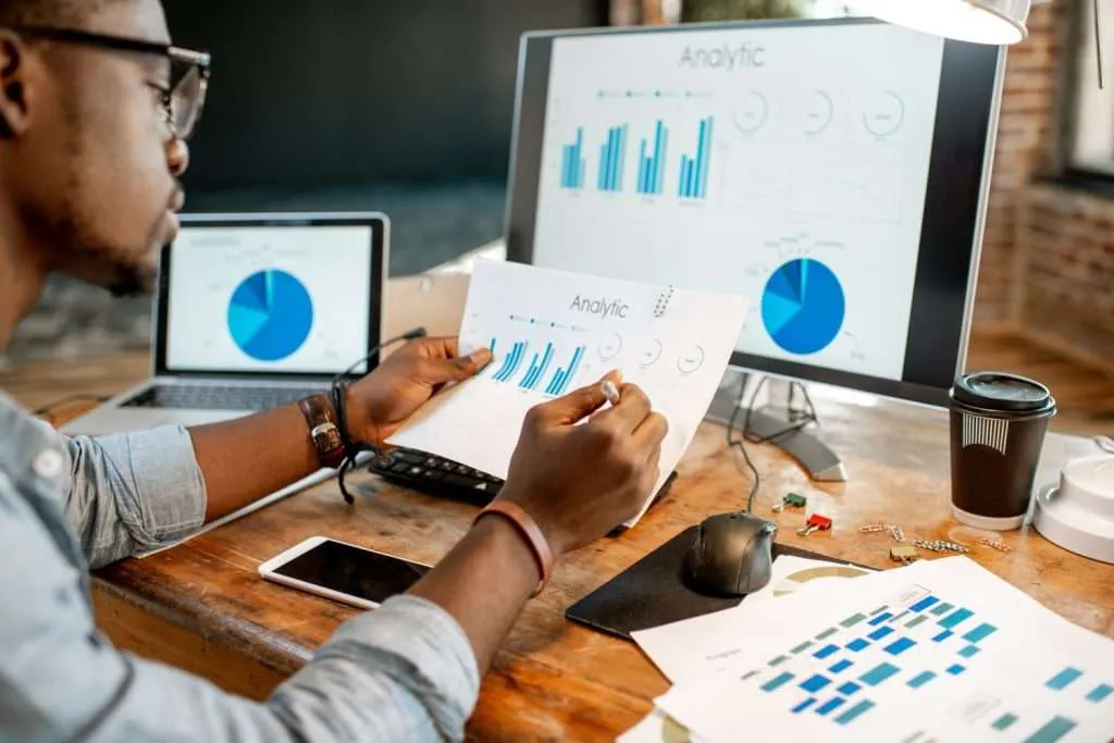 marketing-automation-efficiency-featured Glowing interconnected gears and light paths routing small task tokens automatically above a laptop